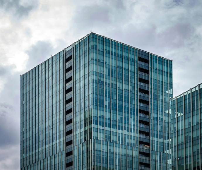 A very tall building sitting under a cloudy sky